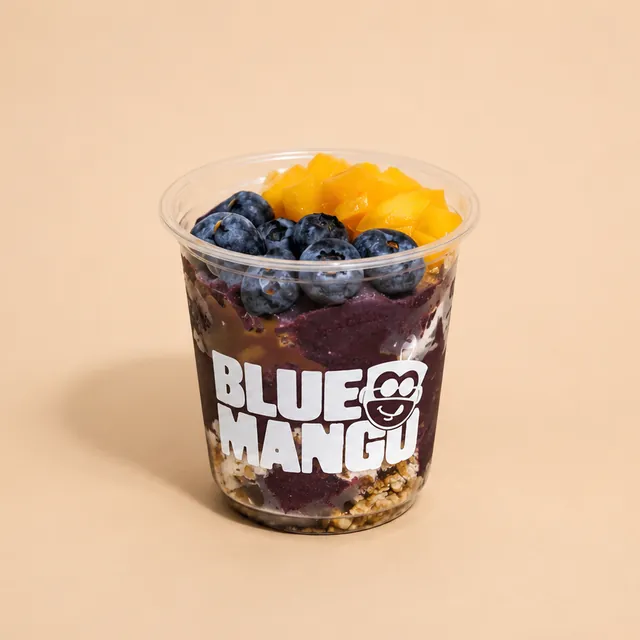 Acai bowl topped with blueberries and fresh mango