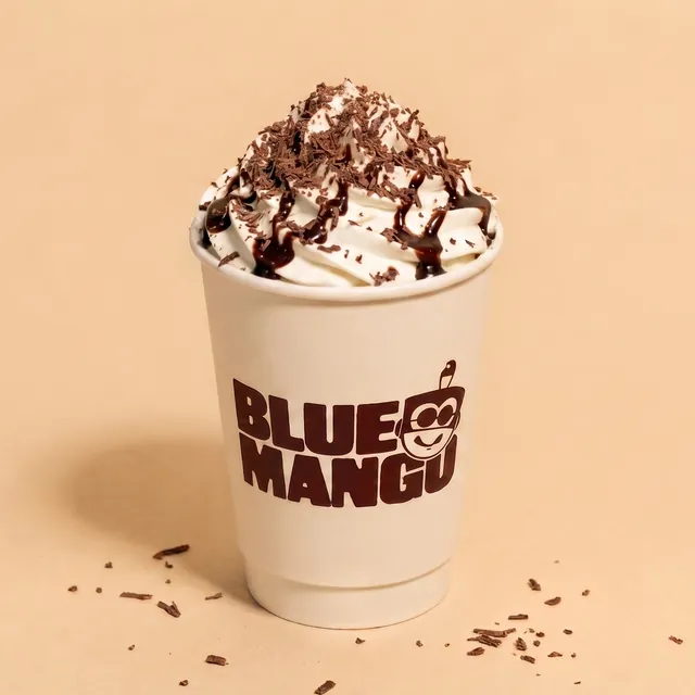 Hot chocolate topped with whipped cream and chocolate shavings
